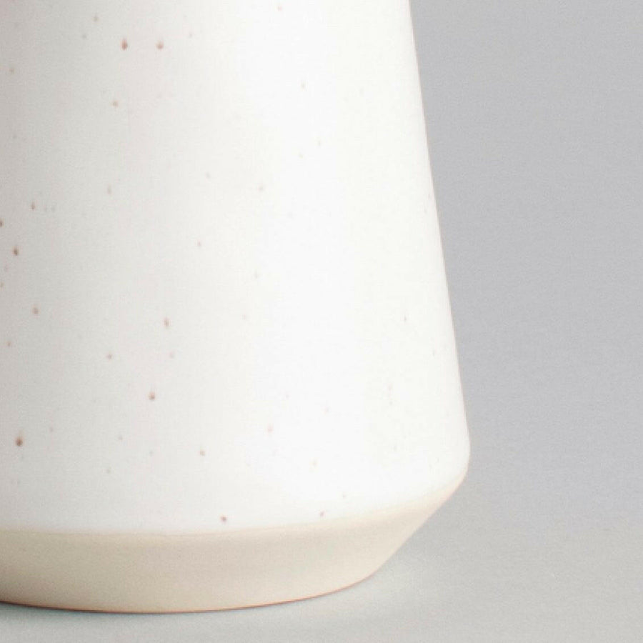 Elegant ceramic cups arranged neatly on a polished wooden table, perfect for morning coffee or tea rituals.