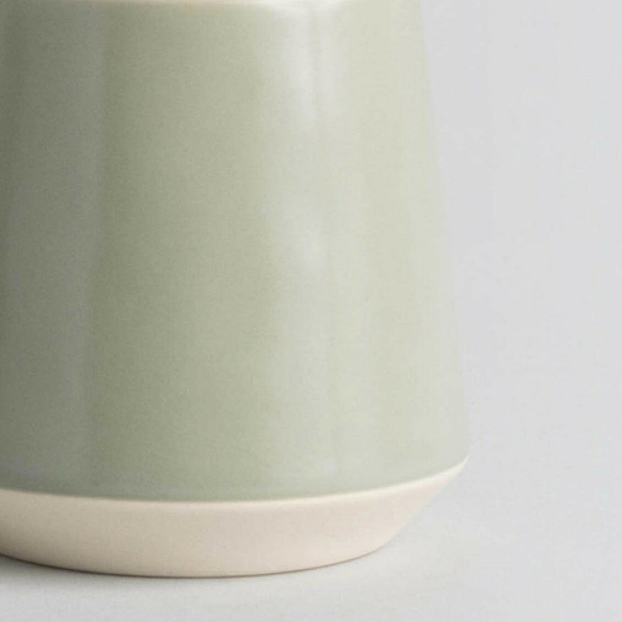 Elegant ceramic cups arranged neatly on a polished wooden table, perfect for morning coffee or tea rituals.
