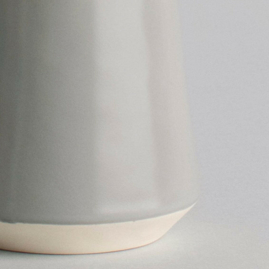 Elegant ceramic cups arranged neatly on a polished wooden table, perfect for morning coffee or tea rituals.