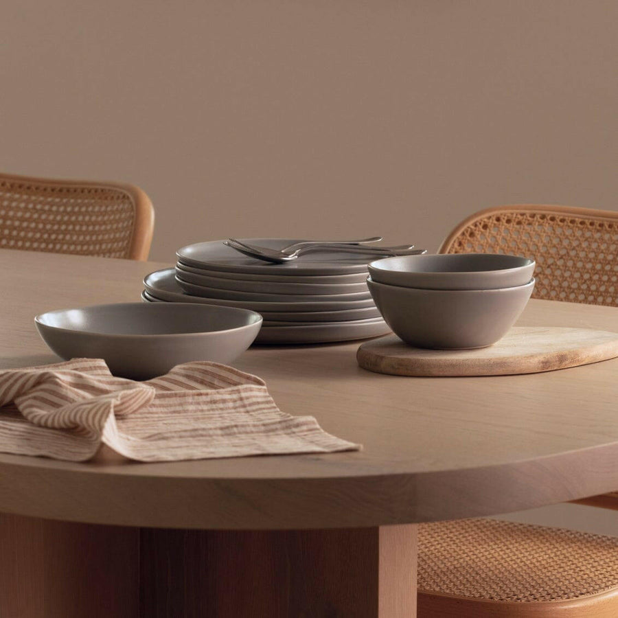 Elegant white porcelain dinnerware set featuring plates and bowls, perfect for formal dining occasions