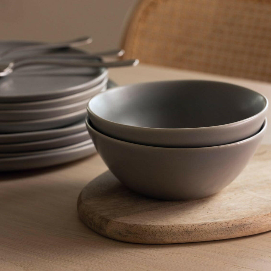 Elegant white porcelain dinnerware set featuring plates and bowls, perfect for formal dining occasions