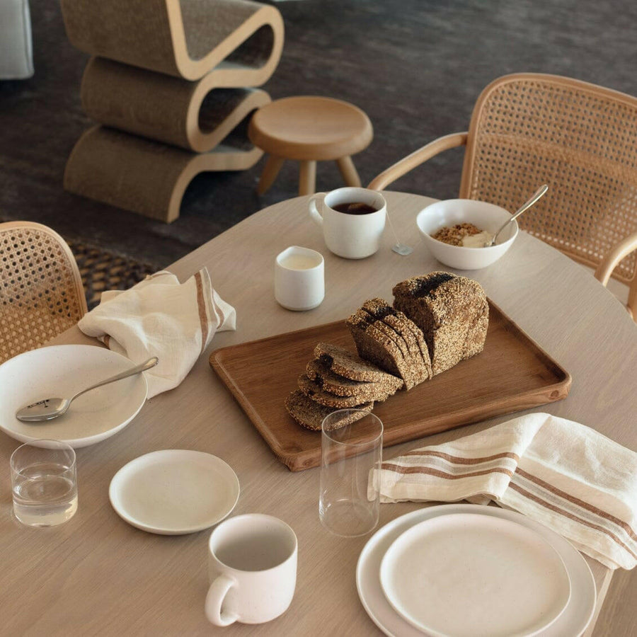 Elegant white porcelain dinnerware set featuring plates and bowls, perfect for formal dining occasions