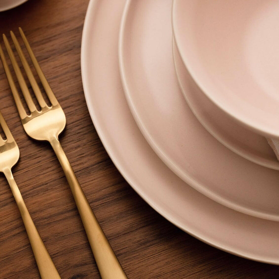 Elegant white porcelain dinnerware set featuring plates and bowls, perfect for formal dining occasions