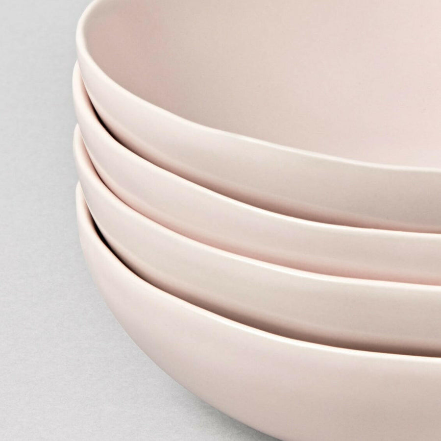 Elegant white porcelain dinnerware set featuring plates and bowls, perfect for formal dining occasions