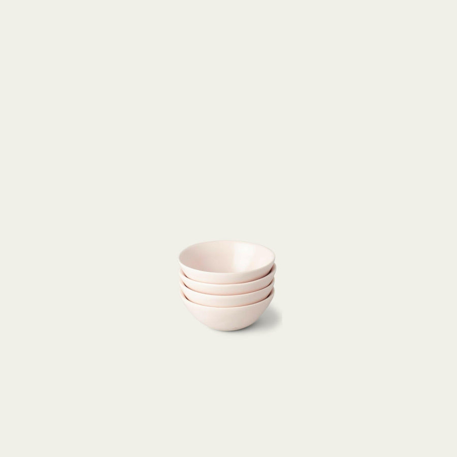 Elegant little bowls displayed on a wooden table, perfect for serving appetizers or desserts in style.