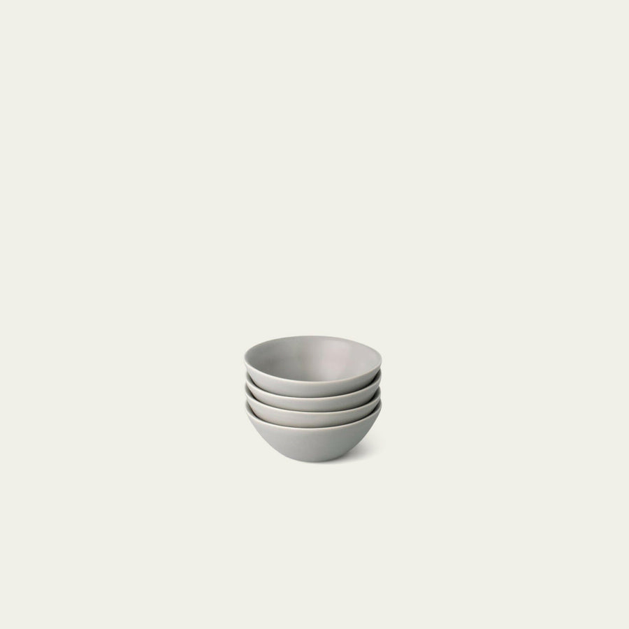 Elegant little bowls displayed on a wooden table, perfect for serving appetizers or desserts in style.