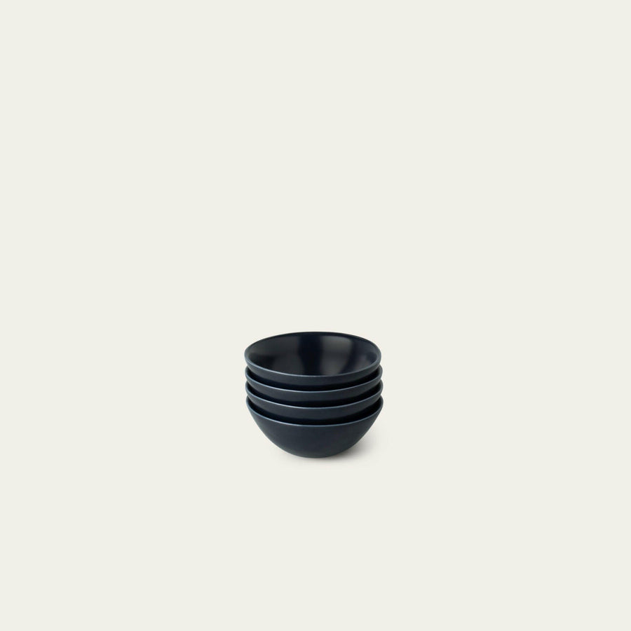 Elegant little bowls displayed on a wooden table, perfect for serving appetizers or desserts in style.