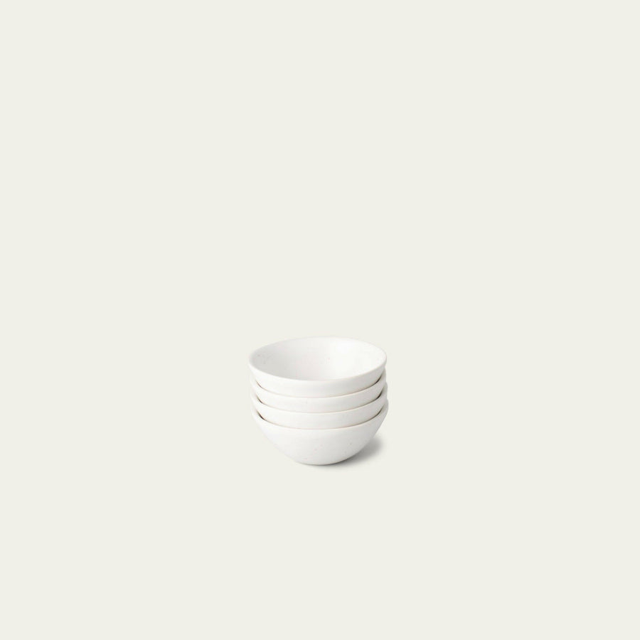 Elegant little bowls displayed on a wooden table, perfect for serving appetizers or desserts in style.
