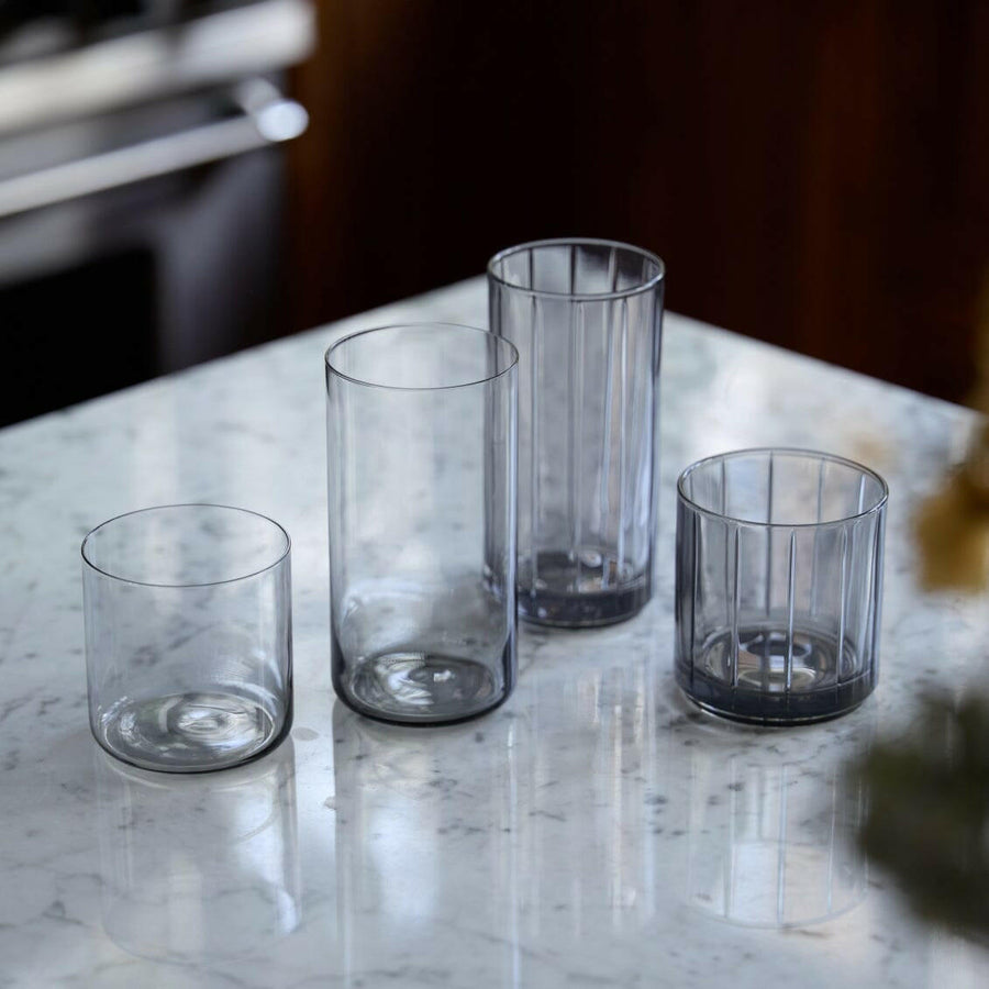 Stylish glasses resting on a bed of natural rocks, highlighting rugged elegance and clarity