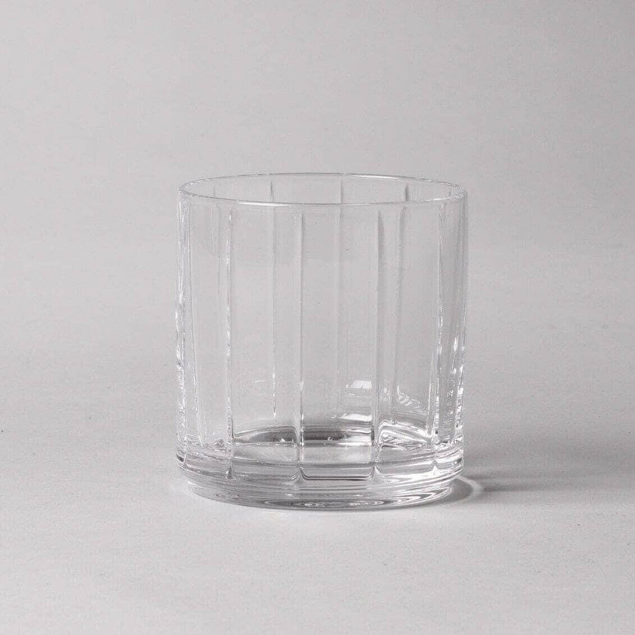 Stylish glasses resting on a bed of natural rocks, highlighting rugged elegance and clarity