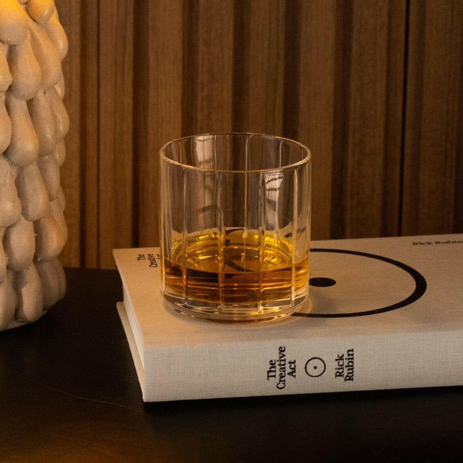 Clear prescription glasses resting on a bed of natural rocks, showcasing durability and style optimization.