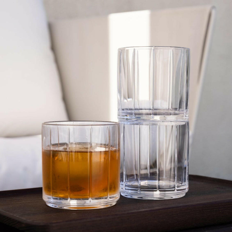 Stylish glasses resting on a bed of natural rocks, highlighting rugged elegance and clarity