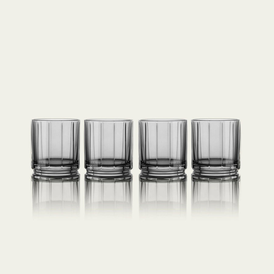 Stylish glasses resting on a bed of natural rocks, highlighting rugged elegance and clarity