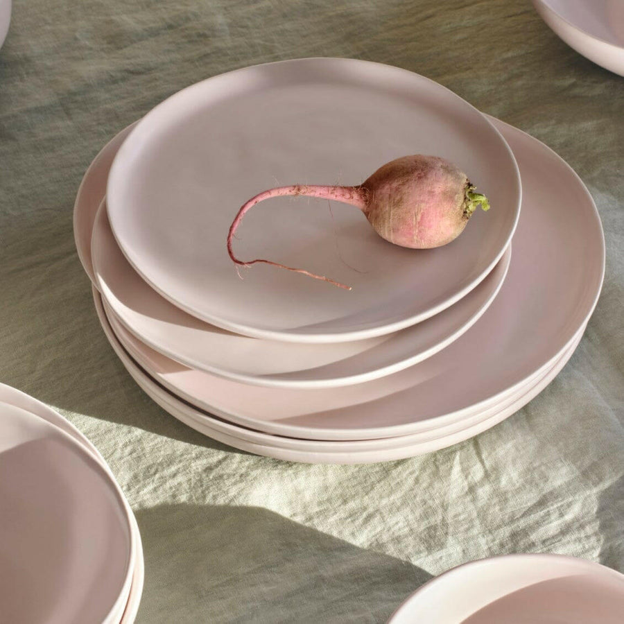 Fresh garden salad served on elegant plates, perfect for a healthy and stylish meal presentation.
